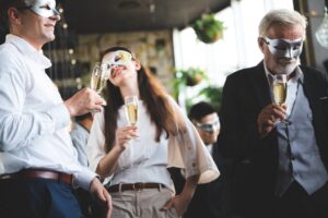 business team party, businessman and businesswomen wearing fancy mask